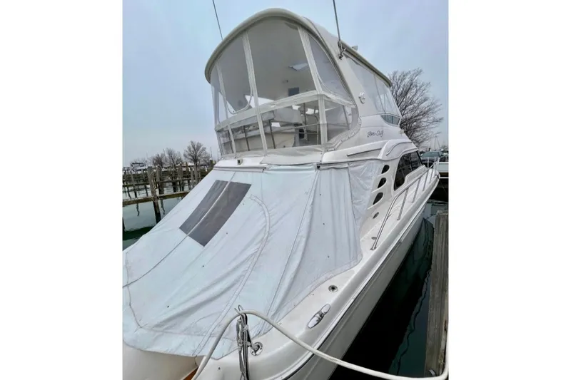 Slide: The Image of 2001 Sea Ray 560 Sedan Bridge yacht docked, covered with protective canvas. - 32