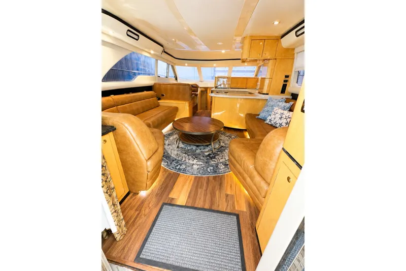 Slide: The Image of Luxurious interior of 2001 Sea Ray 560 Sedan Bridge yacht with leather seating and wooden flooring. - 14