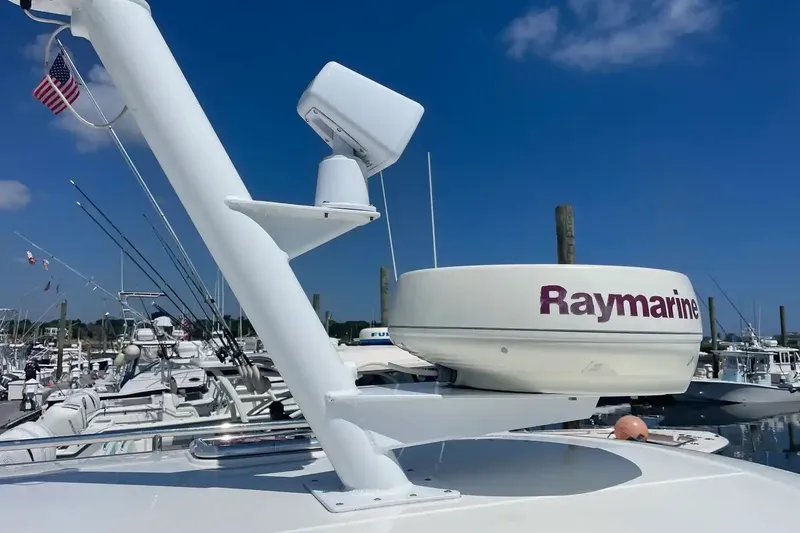 Slide: The Image of Radar equipment on a 2005 Back Cove 29 boat at a marina, clear blue sky. - 18