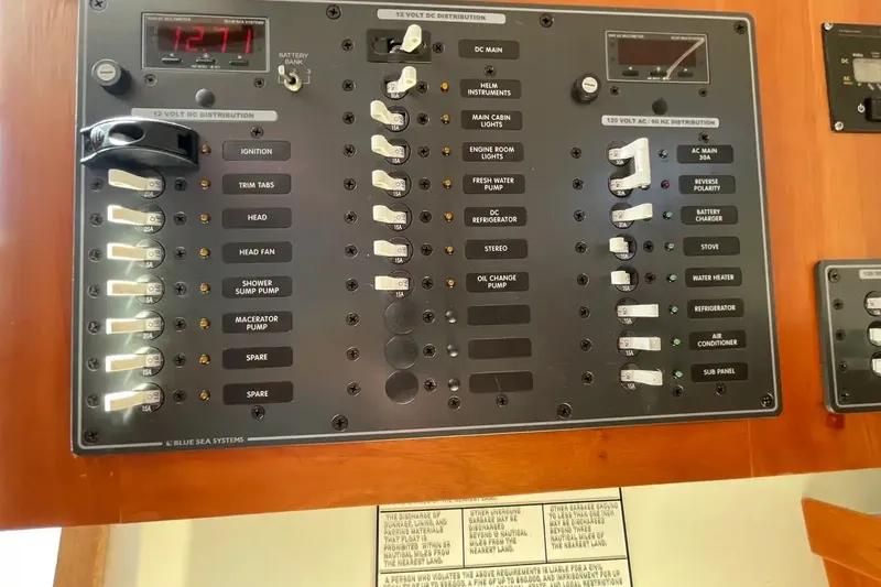 Slide: The Image of Electrical control panel on a 2005 Back Cove 29 boat, featuring various switches and indicators. - 16