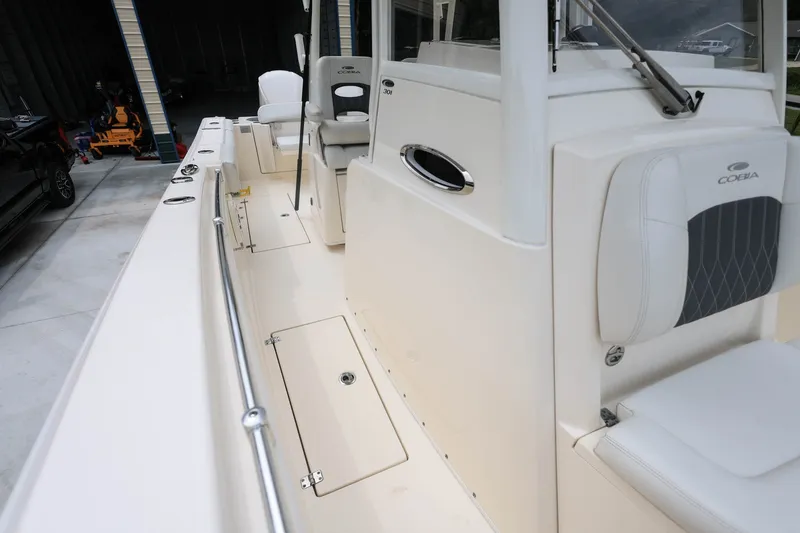 Slide: The Image of 2020 Cobia 301 Center Console boat interior with seating and storage compartments. - 29