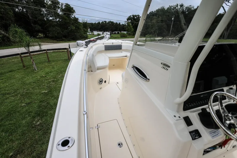 Slide: The Image of 2020 Cobia 301 Center Console boat interior with steering wheel and seating. - 19