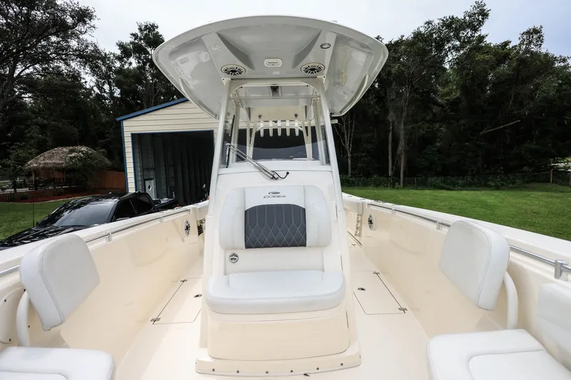 Slide: The Image of 2020 Cobia 301 Center Console boat with spacious seating and sleek design. - 24