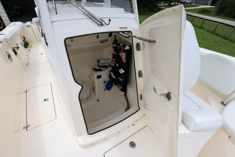 Slide: The Image of 2020 Cobia 301 Center Console boat interior with open storage compartment. - 25