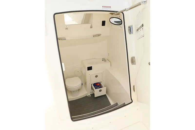 Slide: The Image of Manufacturer Provided Image: 2020 Cobia 301 Center Console boat interior with toilet and storage. - 14