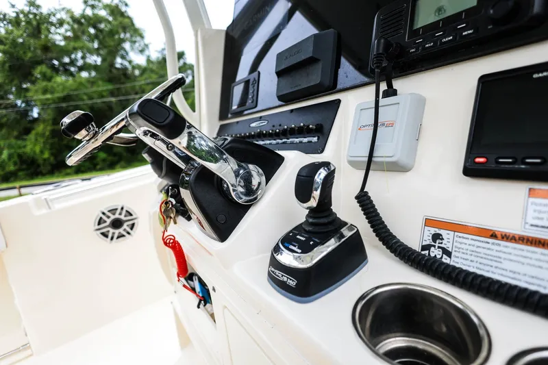 Slide: The Image of 2020 Cobia 301 Center Console boat dashboard with steering wheel and controls. - 18