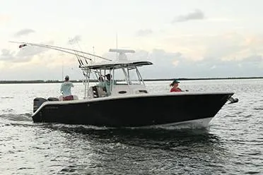 Slide: The Image of Manufacturer Provided Image: 2020 Cobia 301 Center Console boat cruising on the water. - 3