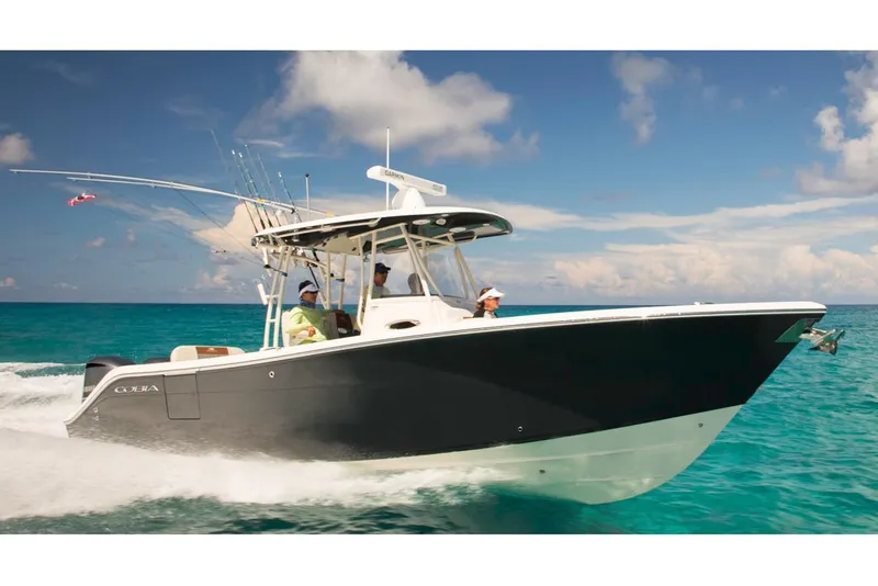 The Image of Manufacturer Provided Image: 2020 Cobia 301 Center Console boat cruising on clear blue water. - 1