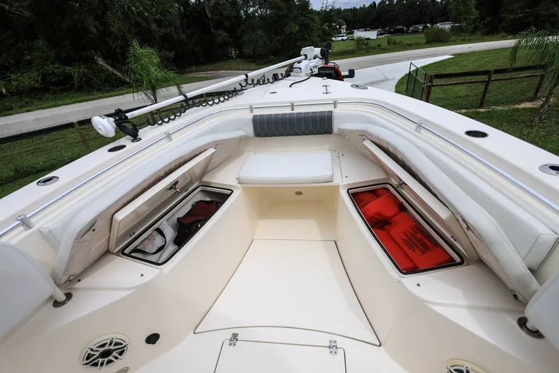 Slide: The Image of 2020 Cobia 301 Center Console boat interior with storage compartments open. - 22