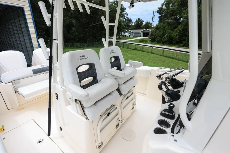 Slide: The Image of 2020 Cobia 301 Center Console boat interior with dual helm seats and steering wheel. - 30