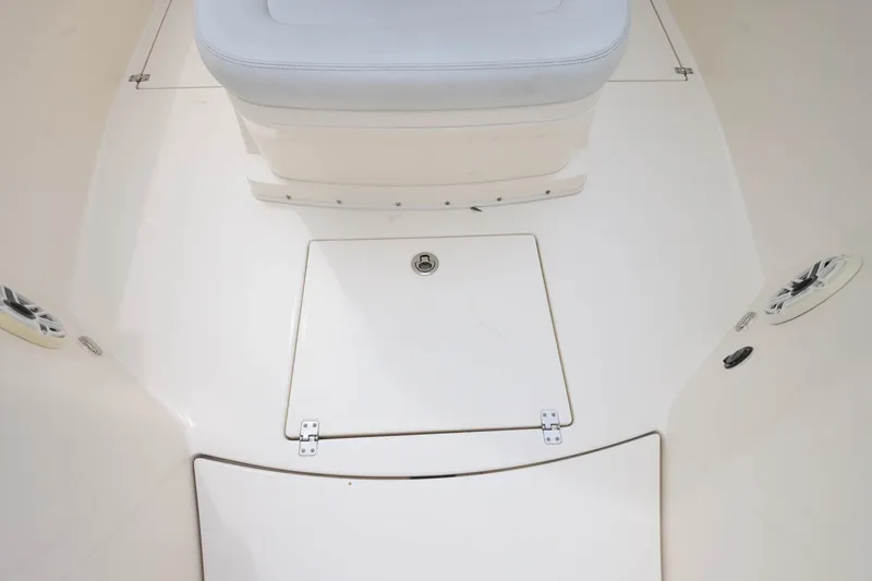 Slide: The Image of 2020 Cobia 301 Center Console boat deck with storage hatch and seating. - 27