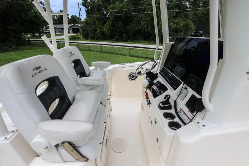 Slide: The Image of 2020 Cobia 301 Center Console boat interior with dual seats and control panel. - 31