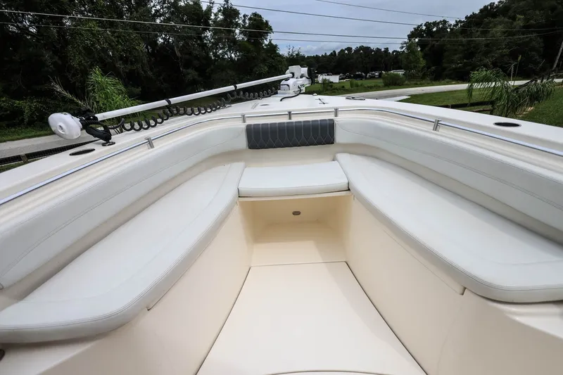Slide: The Image of 2020 Cobia 301 Center Console boat interior with white seating and sleek design. - 21