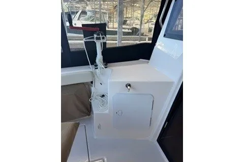 Slide: The Image of 2026 Ranger Tugs R-27 interior with control panel and seating area. - 5
