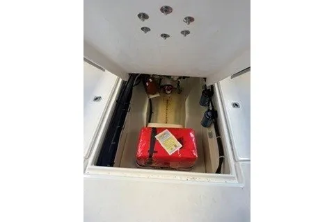 Slide: The Image of 2026 Ranger Tugs R-27 storage compartment with red emergency kit inside. - 4
