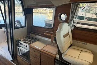 Slide: The Image of Interior of 2026 Ranger Tugs R-27 boat with seating and kitchen area. - 7