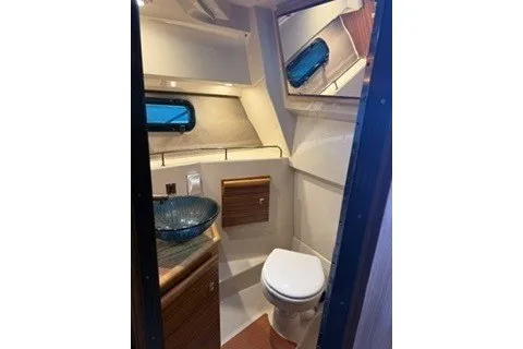 Slide: The Image of 2026 Ranger Tugs R-27 boat bathroom with modern fixtures and compact design. - 16