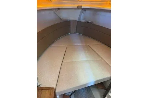 Slide: The Image of 2026 Ranger Tugs R-27 interior cabin with beige seating and modern design. - 13