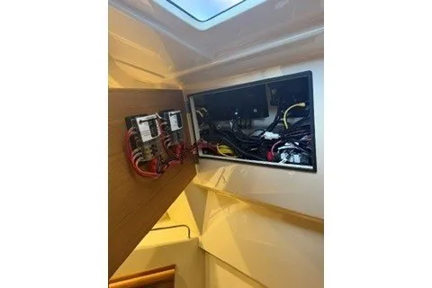 Slide: The Image of Electrical panel inside 2026 Ranger Tugs R-27 boat, showcasing wiring and components. - 18