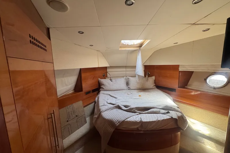 Slide: The Image of Luxurious cabin interior of a 2007 Aicon 64 yacht with cozy bedding and wooden finishes. - 18