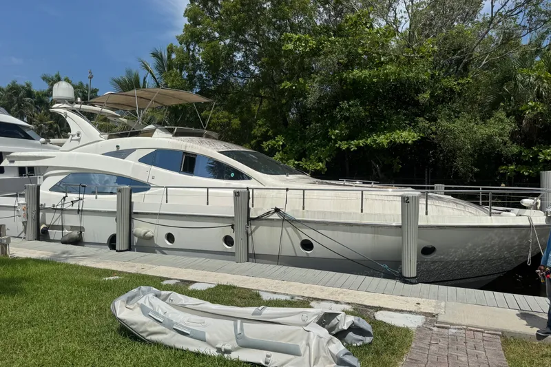 The Image of Aicon 64 yacht from 2007 docked by lush greenery and clear skies. - 0