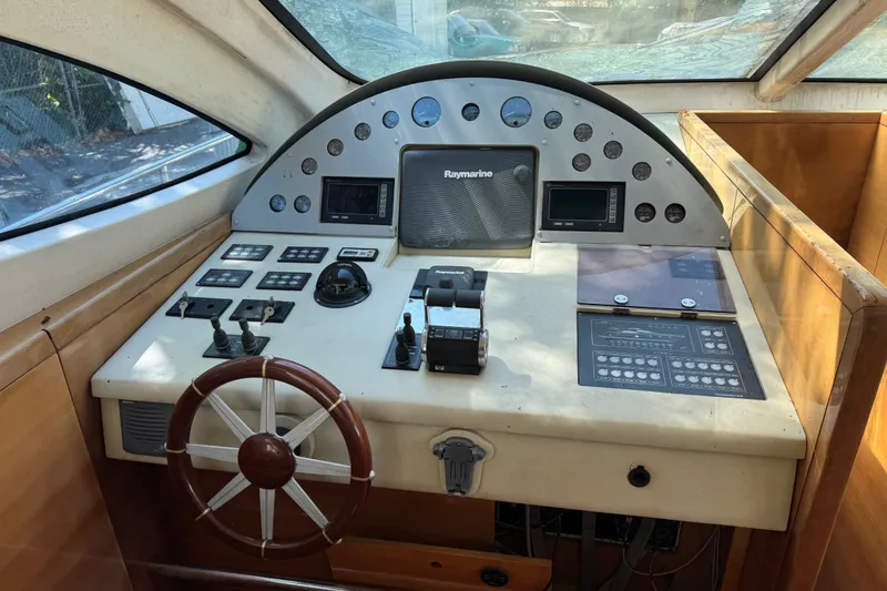 Slide: The Image of Cockpit of a 2007 Aicon 64 yacht with navigation controls and steering wheel. - 13