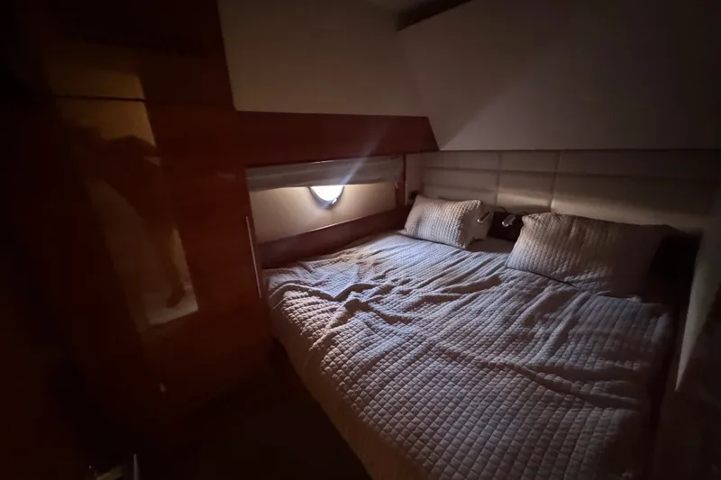 Slide: The Image of Cozy bedroom interior of 2007 Aicon 64 yacht with quilted bedding and soft lighting. - 16