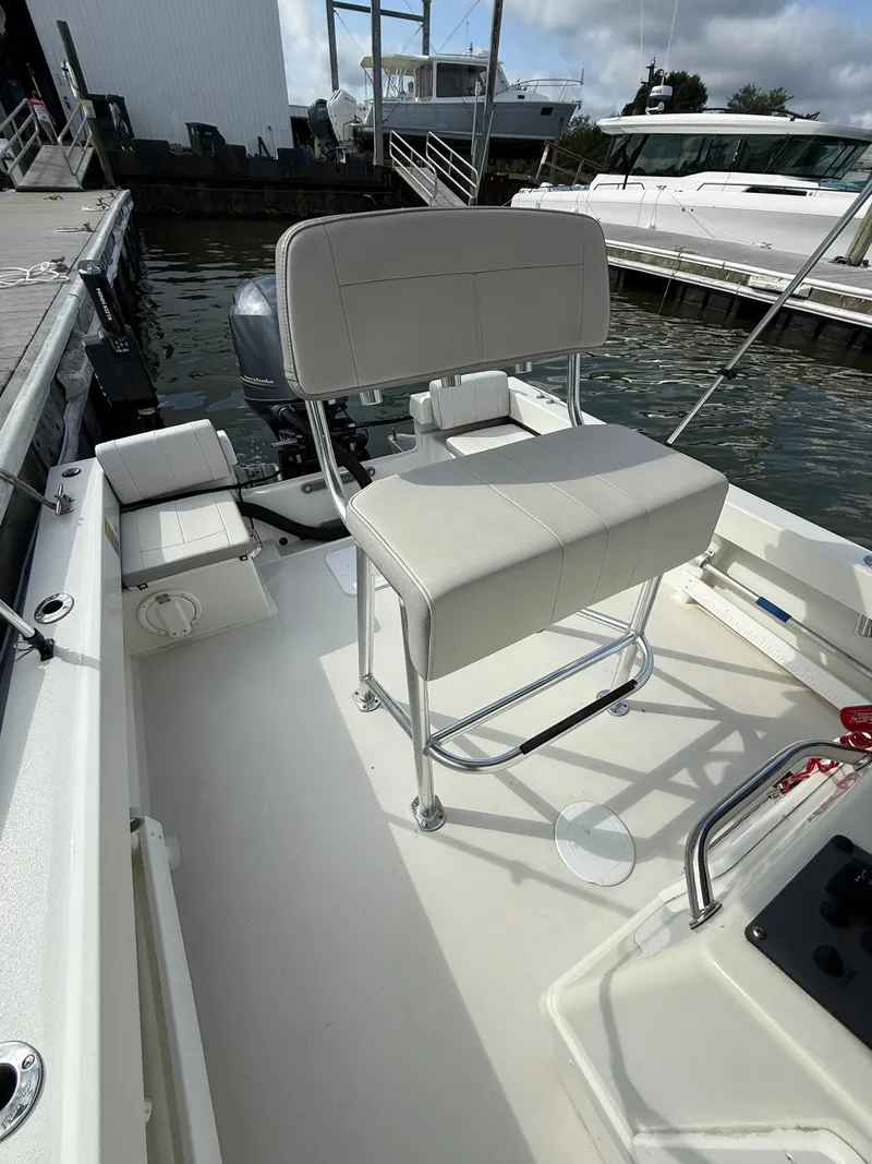 Slide: The Image of A 2021 Parker 1801 Center Console boat with white cushioned seating and stainless steel frame. - 14