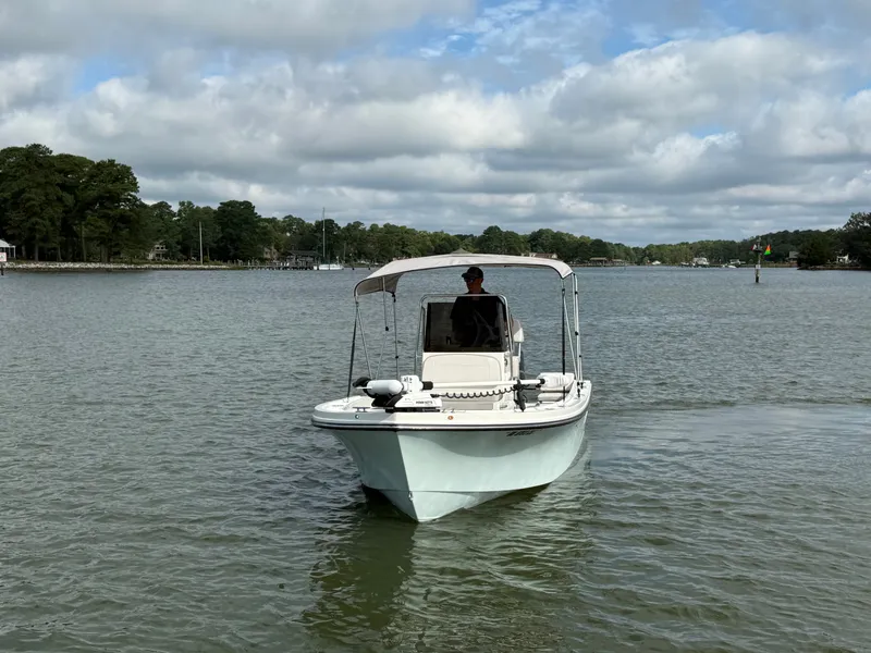 Slide: The Image of A 2021 Parker 1801 Center Console boat on calm waters under a cloudy sky. - 20