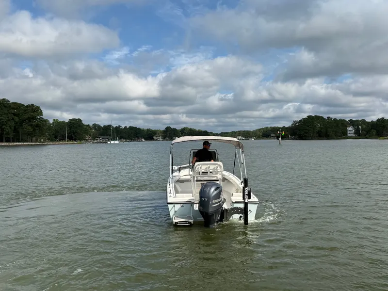 Slide: The Image of A 2021 Parker 1801 Center Console boat on calm waters under a cloudy sky. - 22