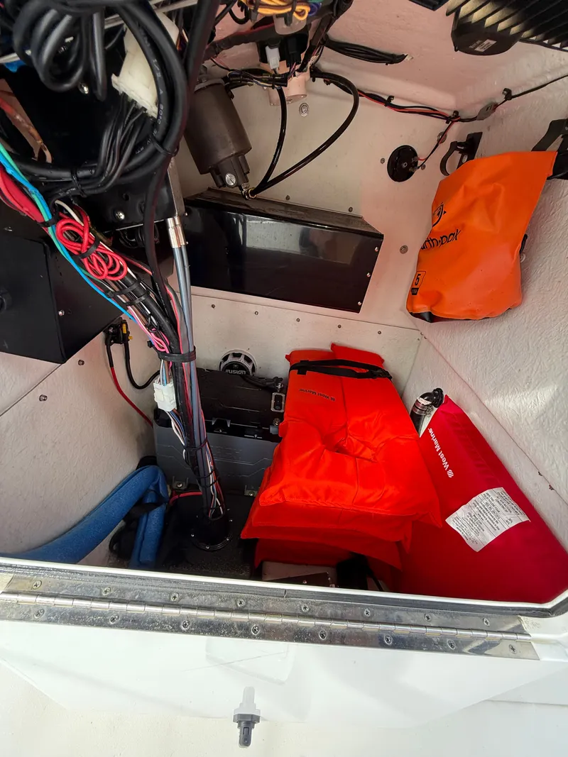Slide: The Image of A boat storage compartment with life jackets, cables, and equipment. - 13