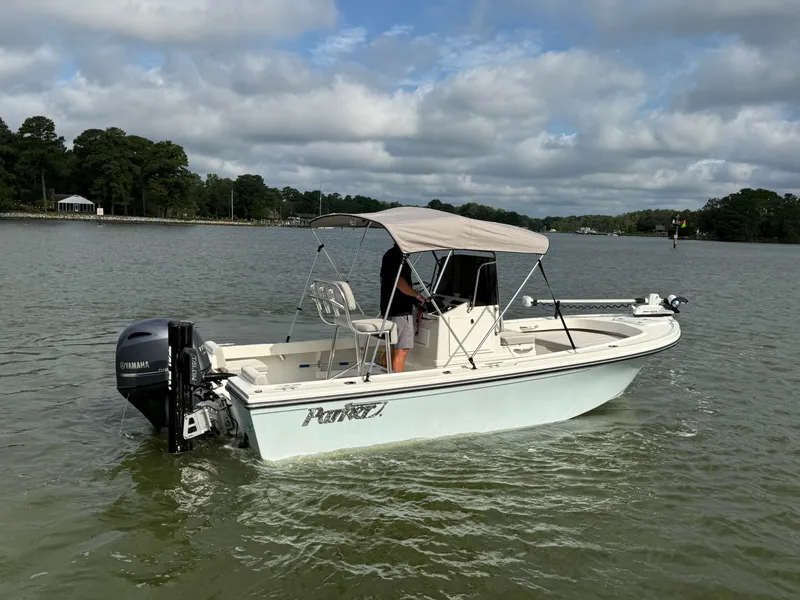 Slide: The Image of A 2021 Parker 1801 Center Console boat on calm waters with a sunshade. - 24