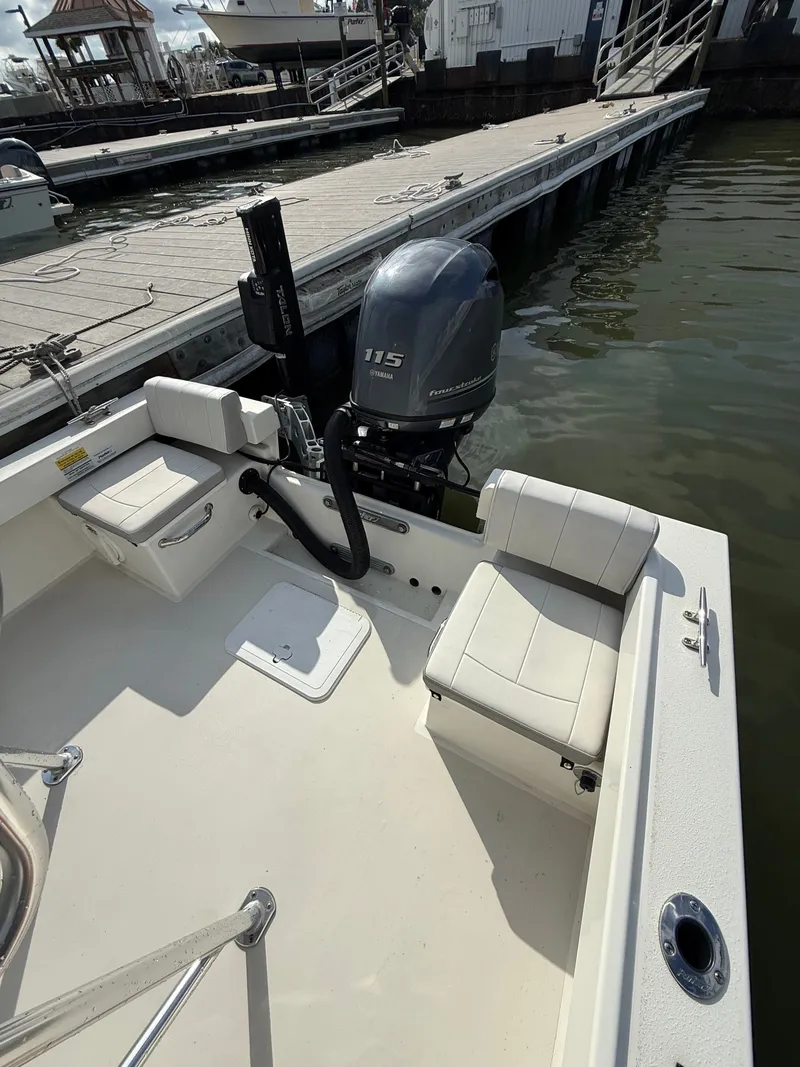 Slide: The Image of A 2021 Parker 1801 Center Console boat docked. It features a 115 HP outboard motor. - 17