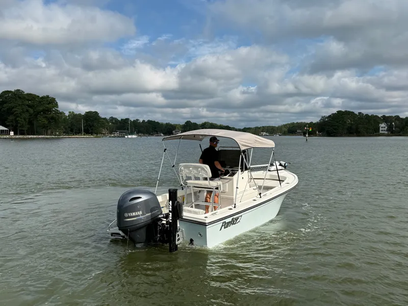 Slide: The Image of A 2021 Parker 1801 Center Console boat on calm waters under a cloudy sky. - 23