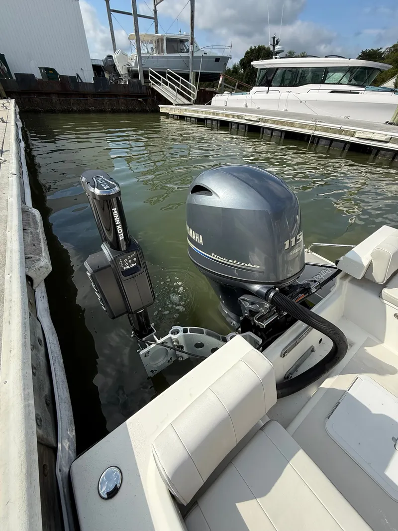 Slide: The Image of A 2021 Parker 1801 Center Console boat docked. It features a Yamaha 115 outboard motor. - 16