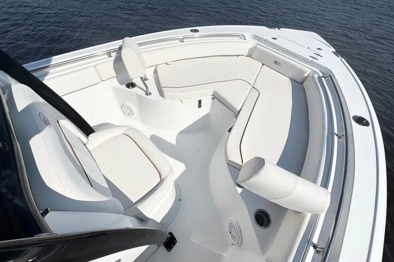 Slide: The Image of 2022 Sea Hunt Ultra 234 boat interior with white seating and sleek design. - 10