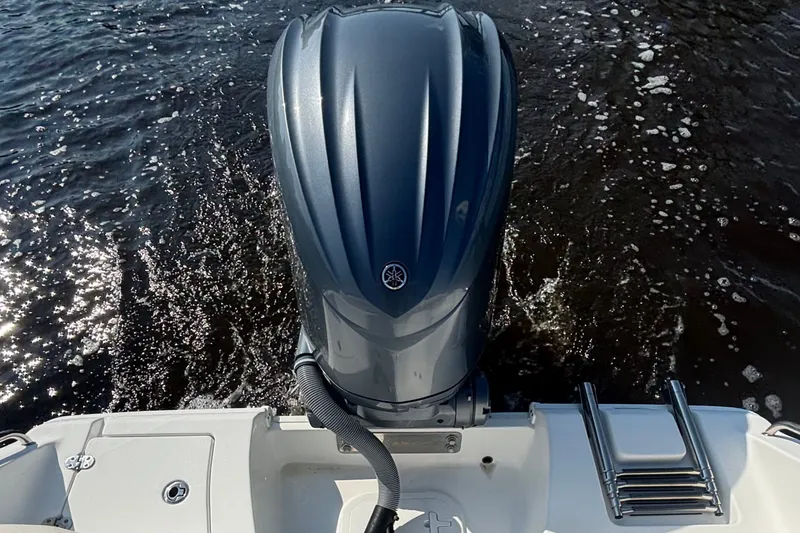 Slide: The Image of 2022 Sea Hunt Ultra 234 boat with Yamaha outboard motor on water. - 13