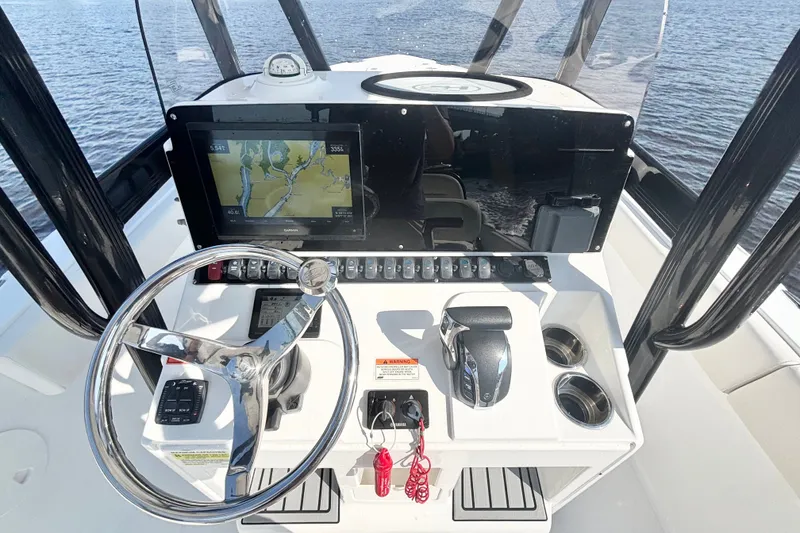 Slide: The Image of 2022 Sea Hunt Ultra 234 boat dashboard with steering wheel and navigation display. - 8