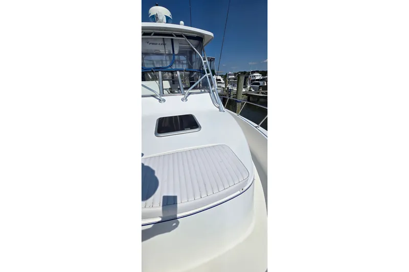 Slide: The Image of 2004 PROLINE 30 Express Walk boat with white deck and cabin, docked at marina. - 6