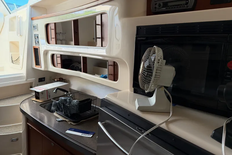 Slide: The Image of Interior of 2009 Grady-White Express 360 boat with kitchen appliances and fan. - 17