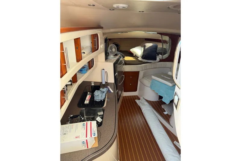 Slide: The Image of Interior of 2009 Grady-White Express 360 boat with wood flooring and cozy seating area. - 13