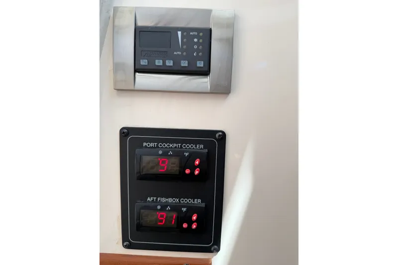 Slide: The Image of Control panels on a 2009 Grady-White Express 360 boat, displaying cooler temperatures. - 24