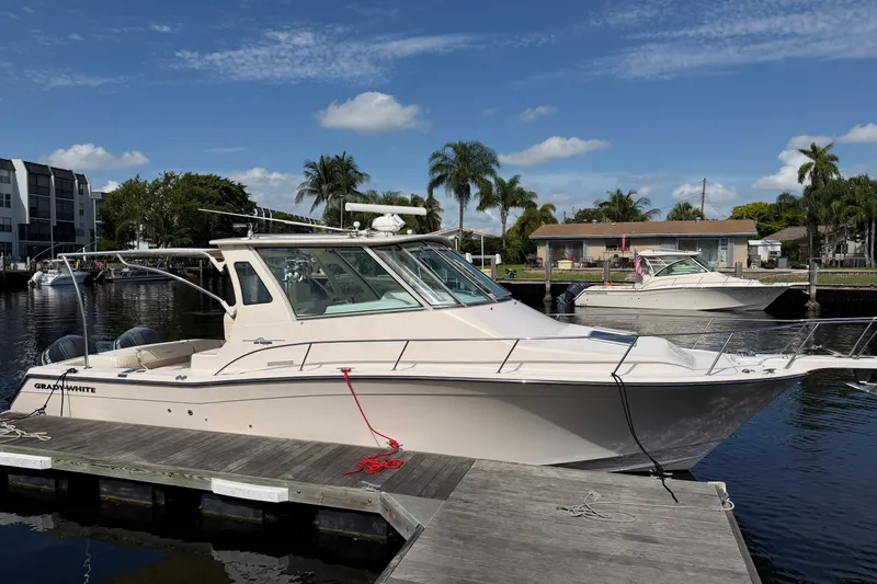 The Image of 2009 Grady-White Express 360 boat docked at marina under clear blue sky. - 0