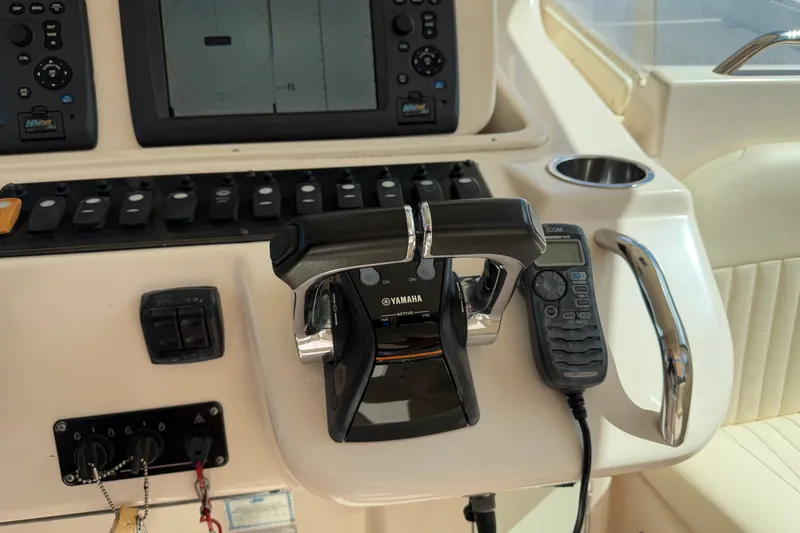 Slide: The Image of Control panel of 2009 Grady-White Express 360 boat with Yamaha throttle and marine radio. - 11