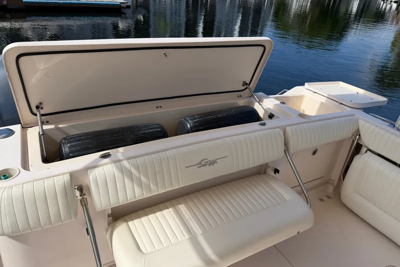 Slide: The Image of 2009 Grady-White Express 360 boat interior with open storage compartment and cushioned seating. - 27