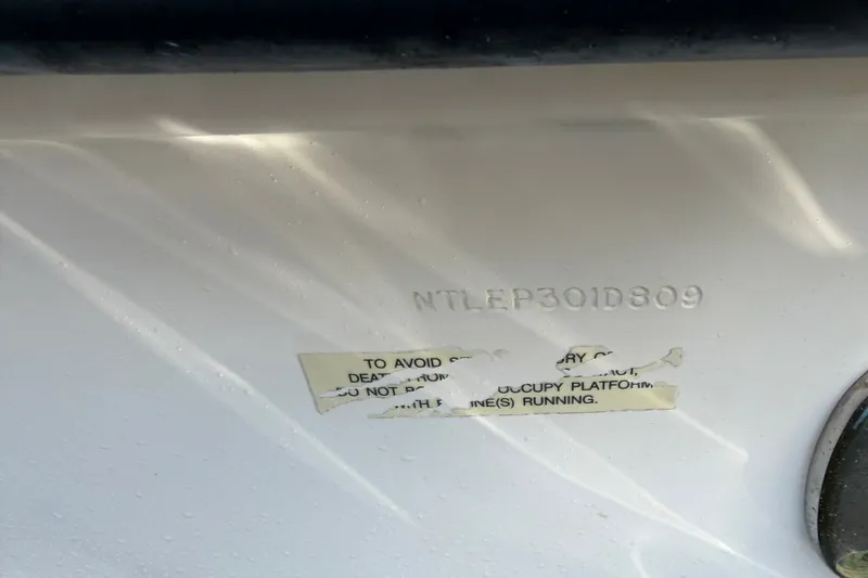 Slide: The Image of 2009 Grady-White Express 360 hull identification number and safety warning label. - 34
