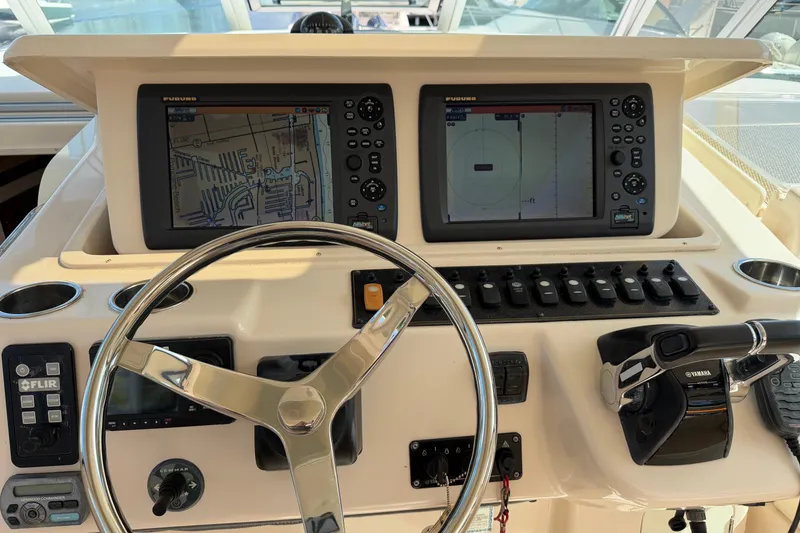 Slide: The Image of 2009 Grady-White Express 360 helm with navigation screens and controls. - 9