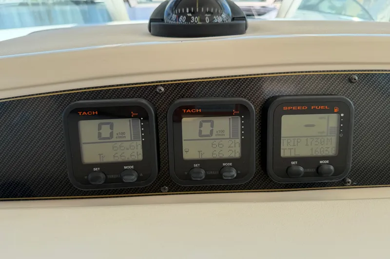 Slide: The Image of Dashboard of a 2009 Grady-White Express 360 boat with tachometer and fuel gauges. - 8