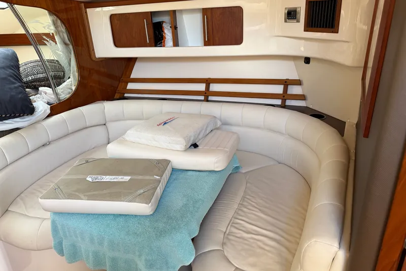 Slide: The Image of Interior of 2009 Grady-White Express 360 boat with cushioned seating and wooden accents. - 15