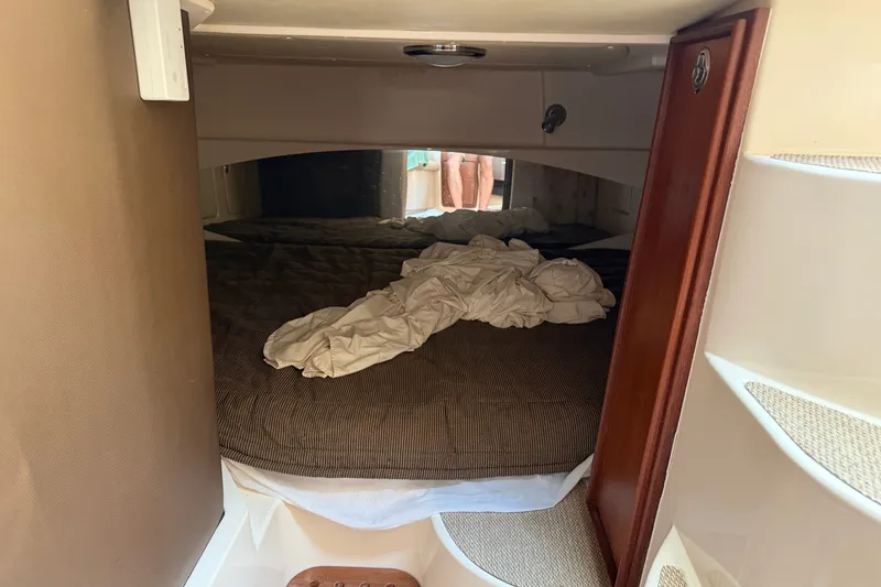 Slide: The Image of 2009 Grady-White Express 360 cabin interior with unmade bed and wooden accents. - 18